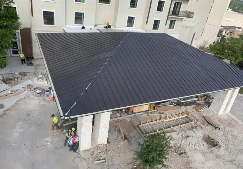 Metal roofing installation team working on a commercial building in Middletown